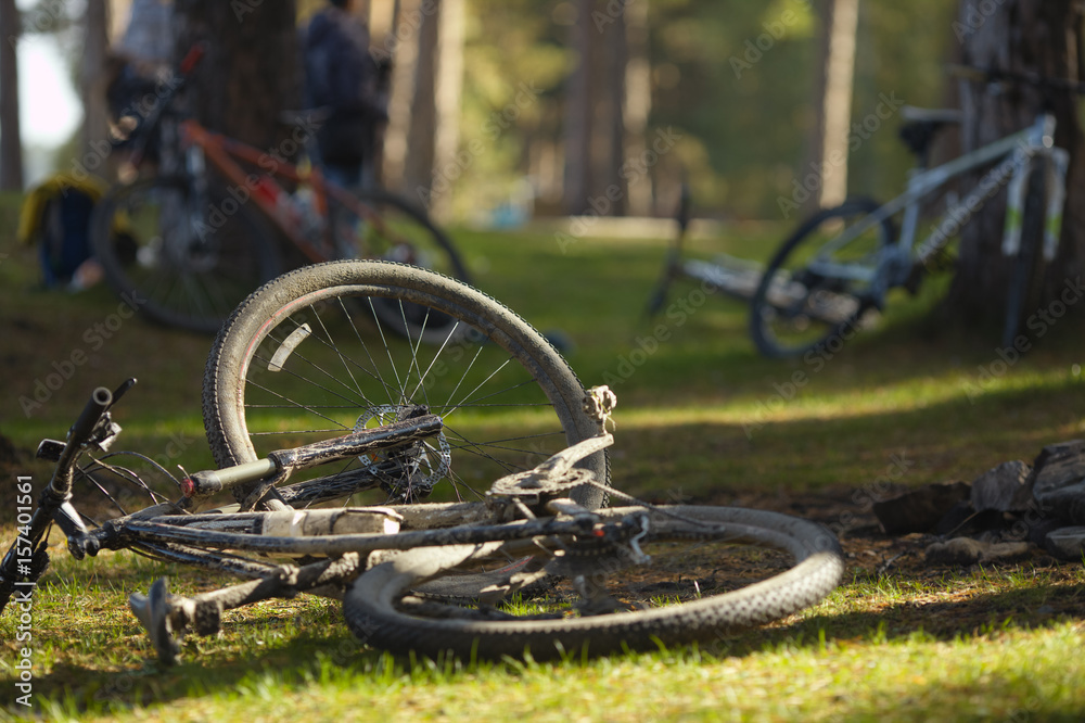 Dirty mountain bike after the competition lying on the grass. Dirty mountain bike after the competition lying on the grass.