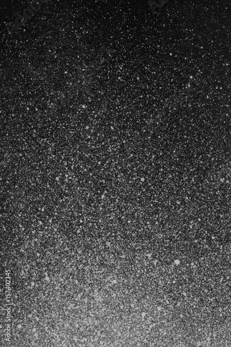 Very hight resolution. Wallpaper with airbrush effect. Black acrylic paint stroke texture on white paper. Scattered mud art. Macro image. Hand made grunge