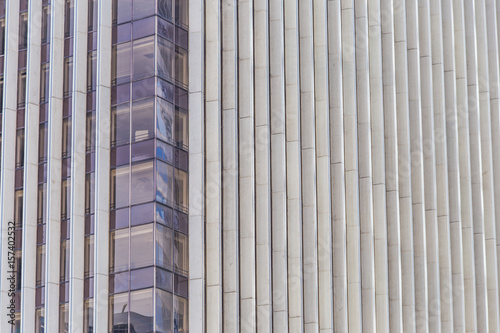 Modern blue glass wall of skyscraper. Business building, office center. Abstract architecture, fragment of modern urban geometry. Background lines