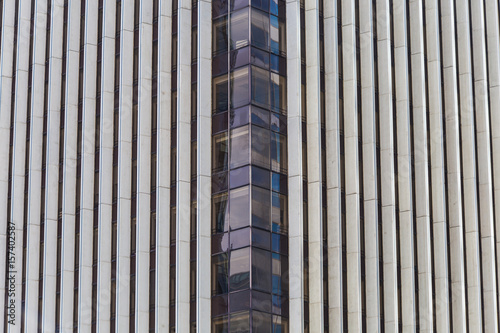 Modern blue glass wall of skyscraper. Business building, office center. Abstract architecture, fragment of modern urban geometry. Background lines