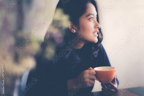 Asian woman with a cup of coffee in free times, Vintage color