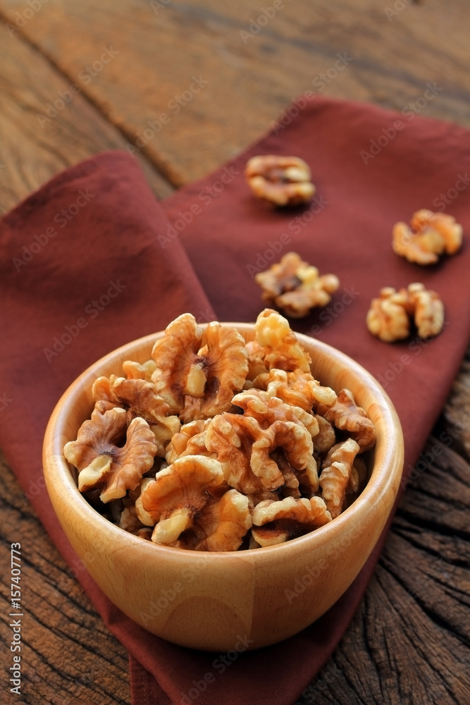Walnut in a bowl put on fabric.