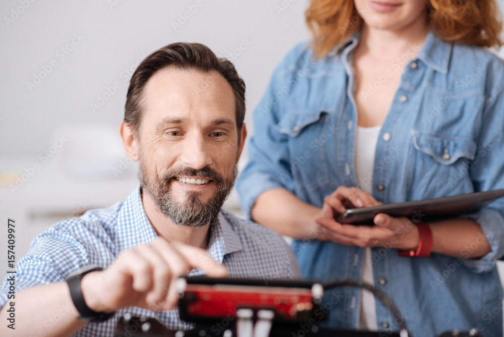 Obraz premium Cheerful delighted man pressing a button