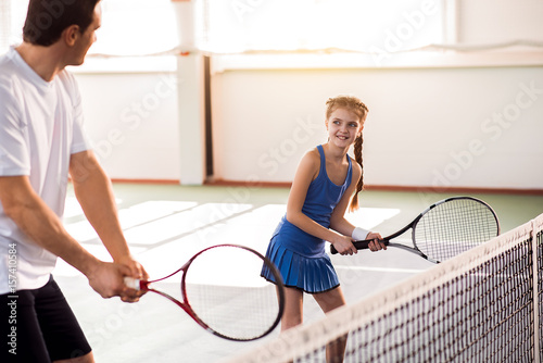 Excited child and dad having fun on tennis court © Yakobchuk Olena