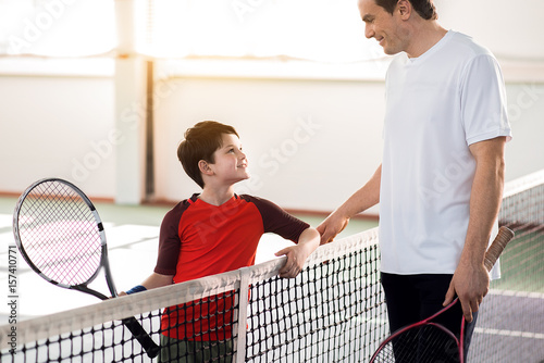 Joyful man praising his child for good playing