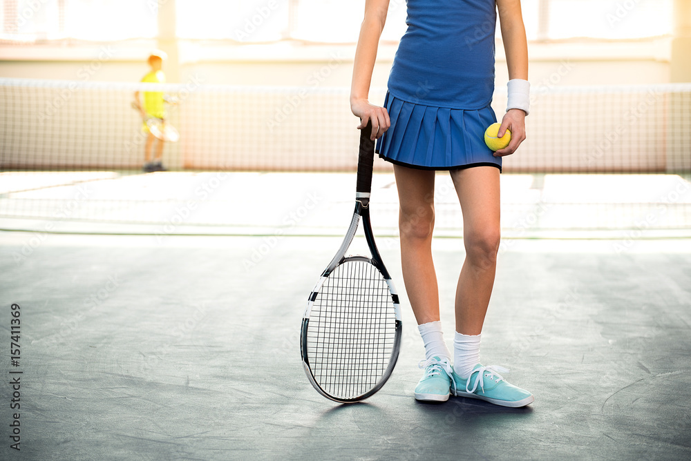 Female child playing tennis indoors