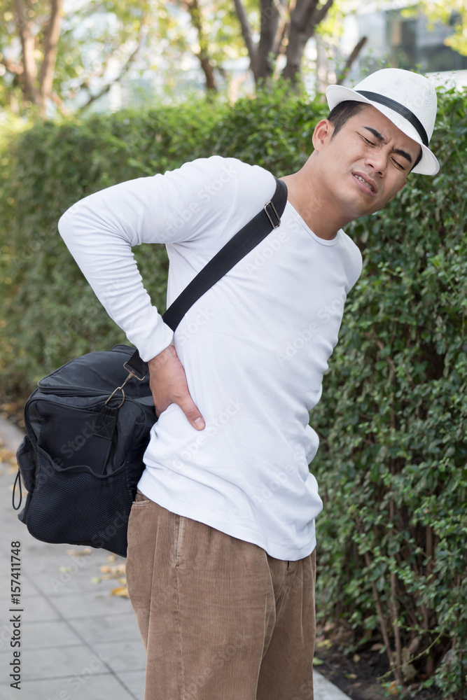 back pain man carrying heavy bag Stock Photo Adobe Stock