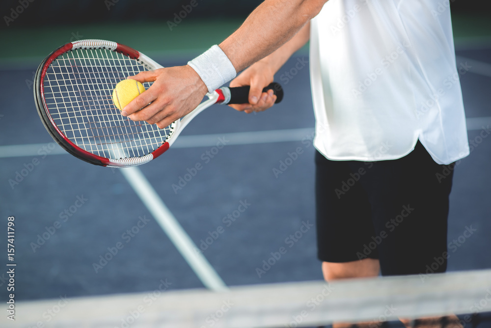 Sportsman using tennis racket for pitch