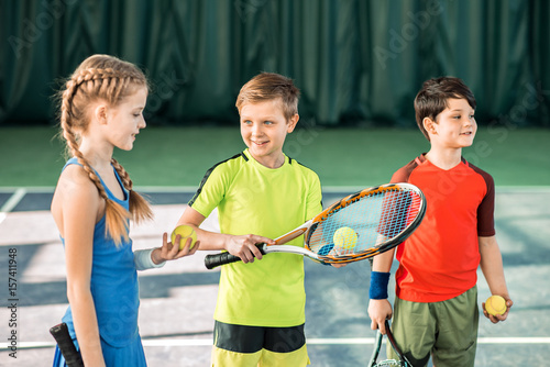 Happy children playing tennis on playground © Yakobchuk Olena