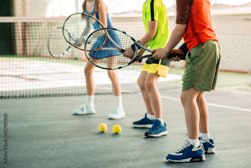 Cheerful kids having fun with tennis racquets © Yakobchuk Olena