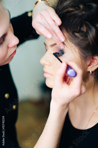 stylist working in a beauty salon and a nice lady