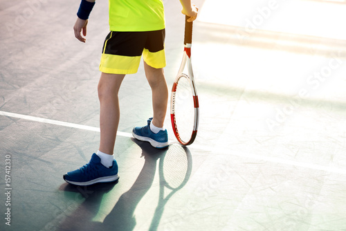 Male child playing tennis on playground © Yakobchuk Olena