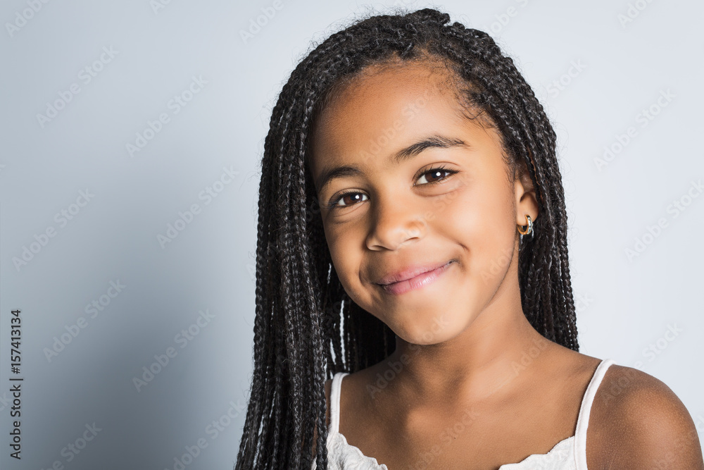 Adorable african little girl on studio gray background Adorable african little girl on studio gray background