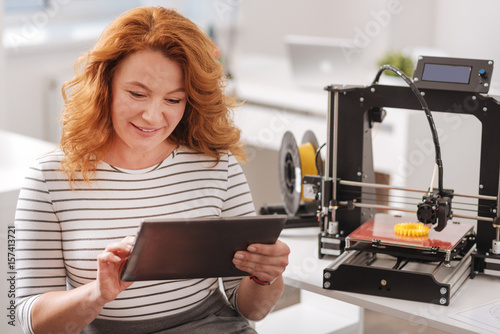 Cheerful pleasant woman using a tablet