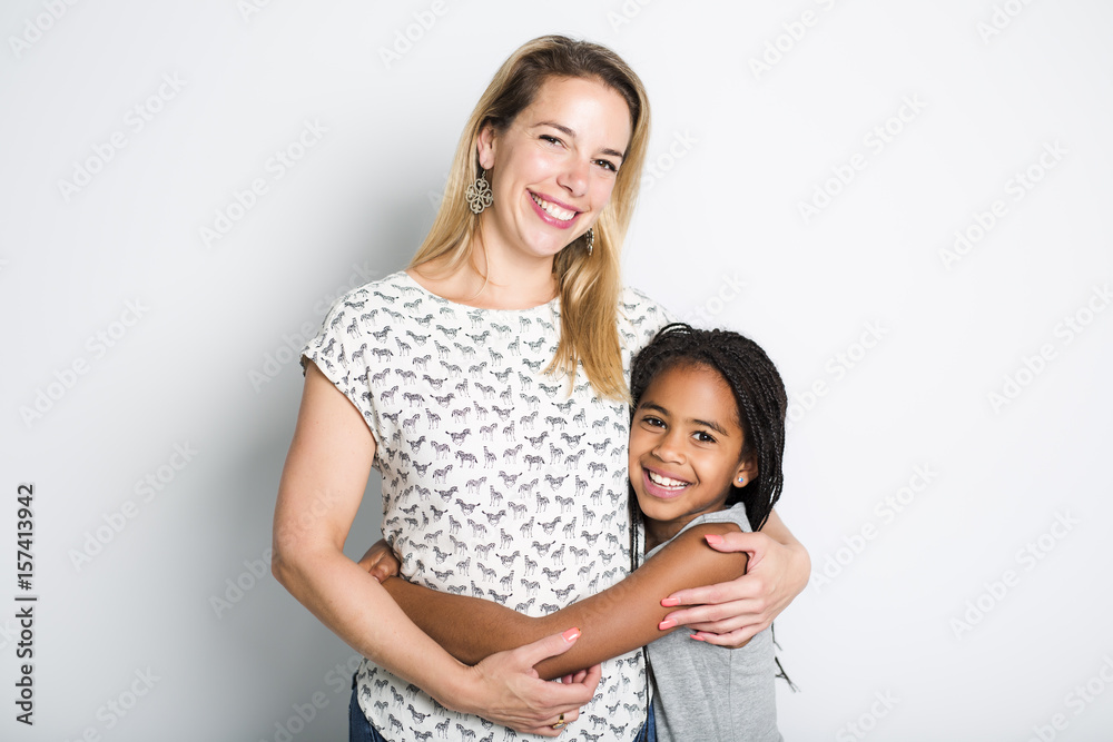 black girl with her mother, isolated on gray background black girl with her mother, isolated on gray background
