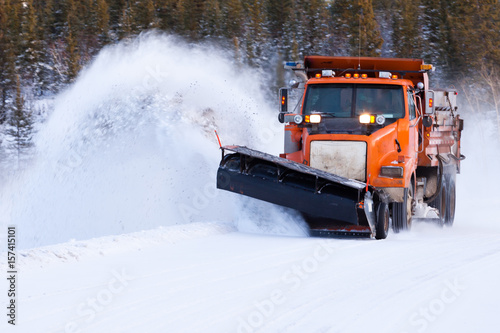Snow plow clearing road after winter snow storm