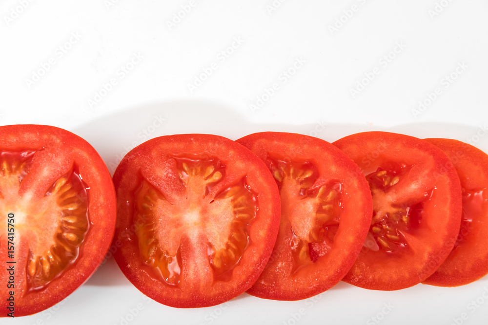 sliced red tomatoes with green branches on a light background isolate sliced red tomatoes with green branches on a light background isolate