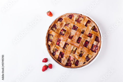 Toasted rye rhubarb pie with strawberry. Top view on white background with copy space