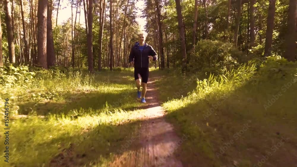 Man running in the morning forest.