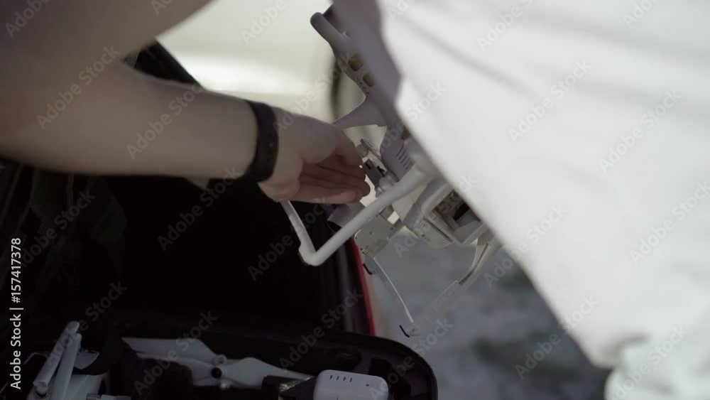 Man preparing quadcopter for take off outdoors Man preparing quadcopter for take off outdoors