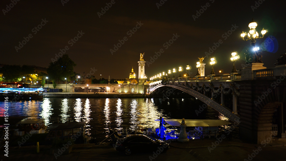 Night shot from iconic illuminated Alexander III bridge, Paris, France