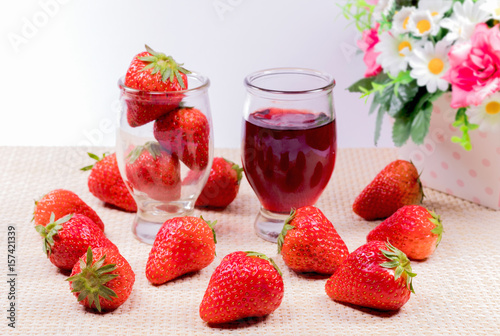 Fresh strawberries and strawberry jam in the glass jar