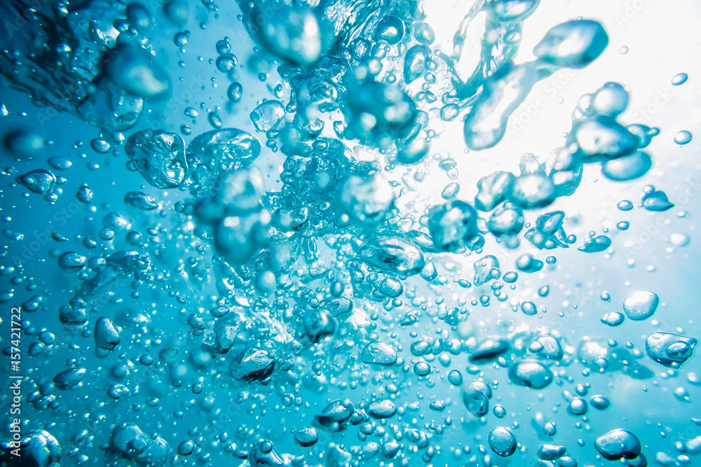 Water bubbles in underwater in blue ocean, water texture.