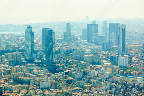 Istanbul, Turkey - 1 April, 2017: Urban landscape of European side of Istanbul and Bosphorus Strait on a horizon. Modern part of city with business towers of international corporations, skyscrapers