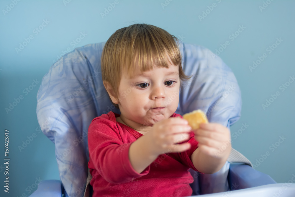 Baby boy eating cheese pie - gibanica Baby boy eating cheese pie - gibanica