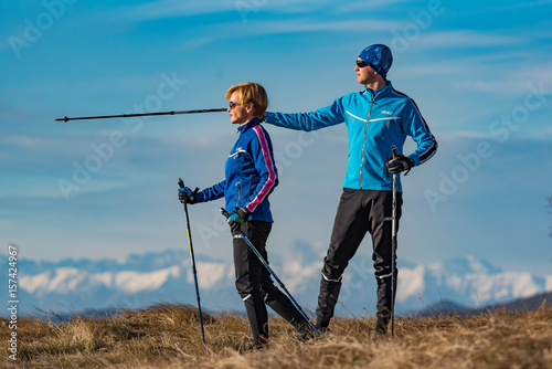 Couple admires a landscape during a Nordic walking
