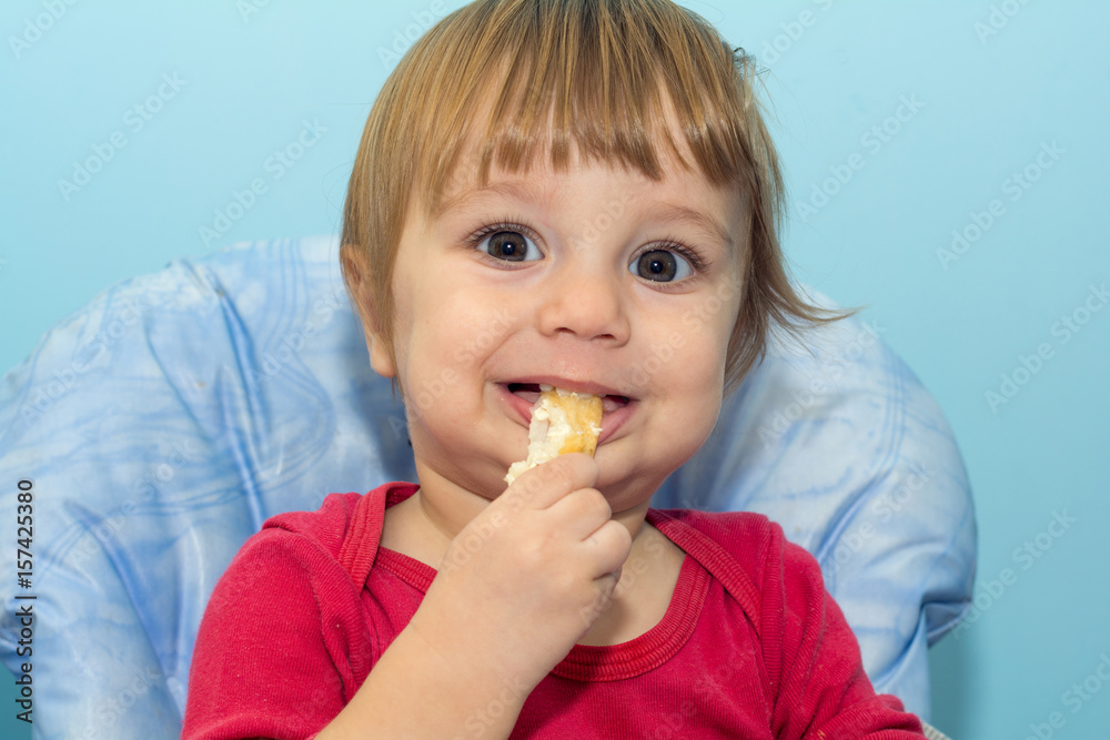 Baby boy eating cheese pie - gibanica Baby boy eating cheese pie - gibanica