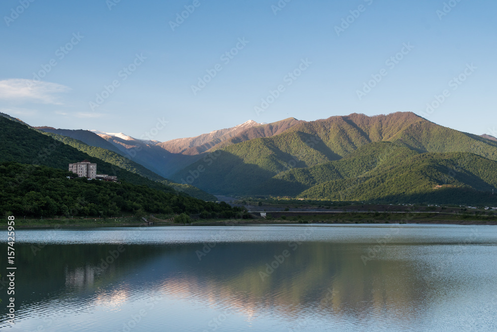 Castle in georgian mountains with reflection in the lake