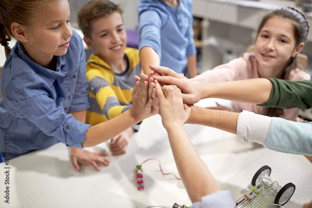 happy children making high five at robotics school Stock Photo | Adobe ...