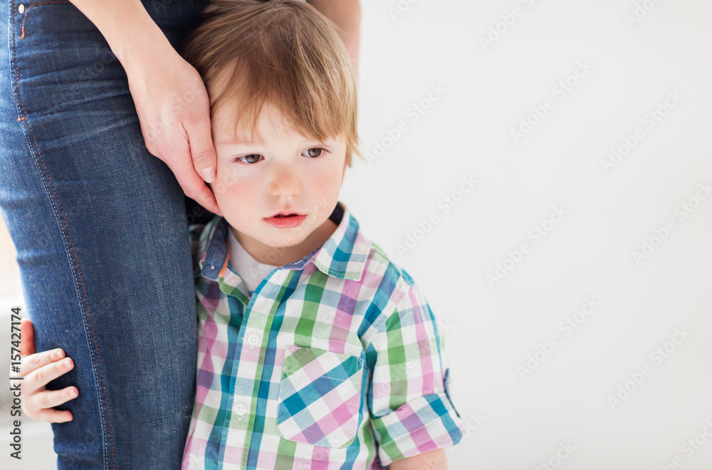 sad little boy holding to mother sad little boy holding to mother