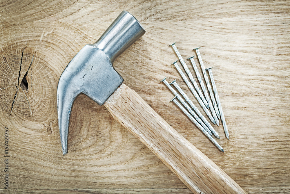 Claw hammer construction nails on wooden board top view building Claw hammer construction nails on wooden board top view building