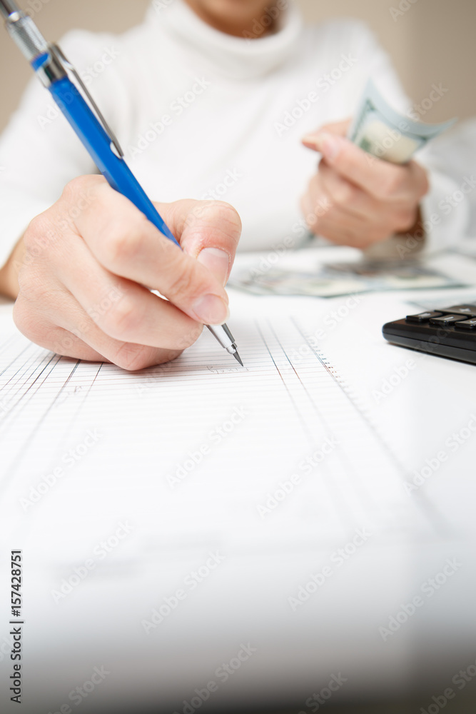 Entrepreneur calculating and reviewing investment plan