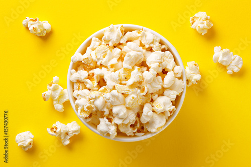 Popcorn viewed from above on yellow background. Flat lay of pop corn bowl. Top view