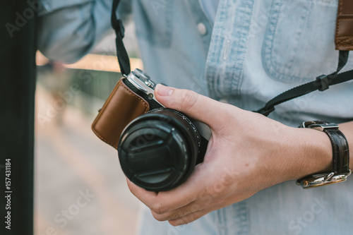 Mirrorless camera held in hand photo