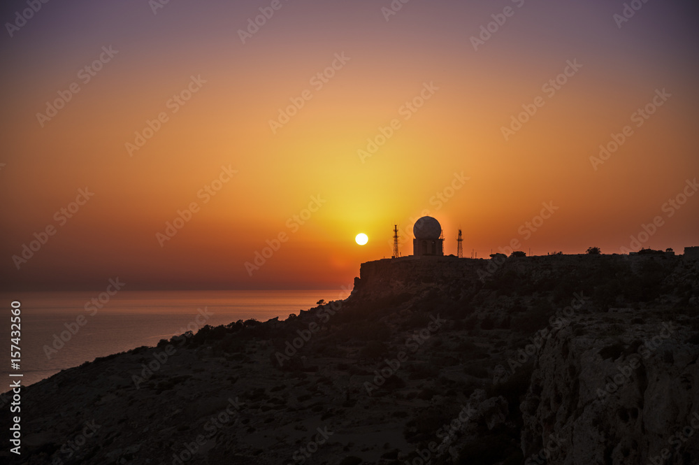 Scenic View Of Sea Against Sky During unset,Dingli Cliffs, Malta.From the distance you can see the metrological station