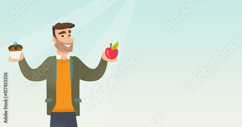 Man choosing between apple and cupcake.