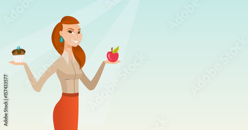 Woman choosing between apple and cupcake.