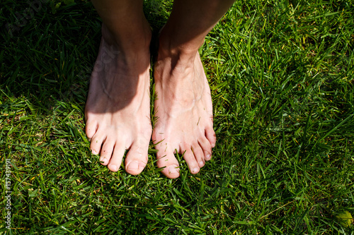 Female legs on green grass