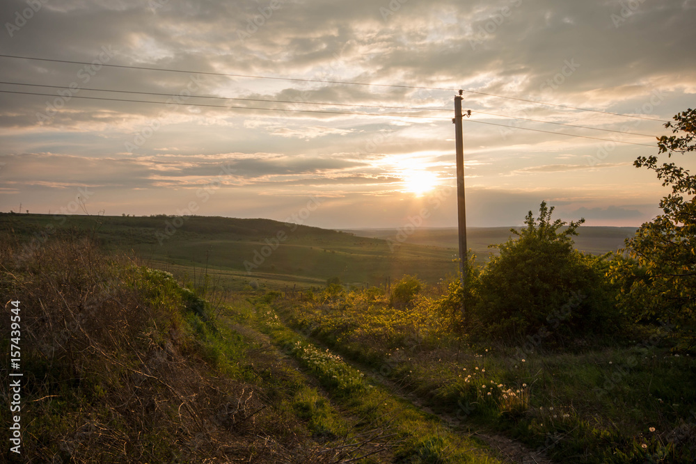 Golden sunset. Moldavian fields and hills. Spring or summer sunny down landscape.