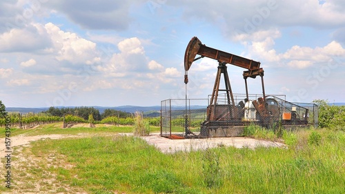 Oil well on a landscape photo