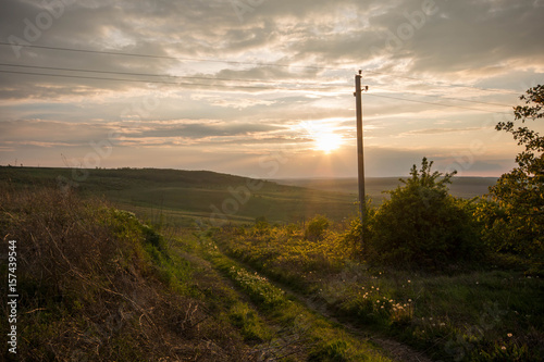 Golden sunset. Moldavian fields and hills. Spring or summer sunny down landscape.