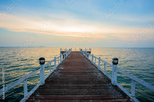 The wooden bridge on sea at sunset, Thailand.