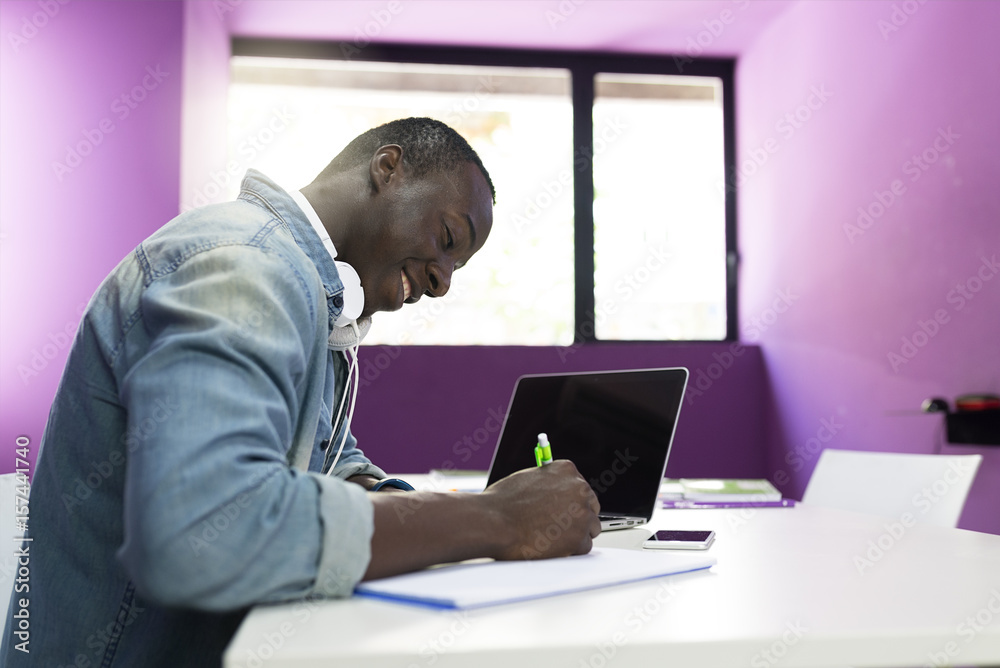 Handsome african man learning at classroom.