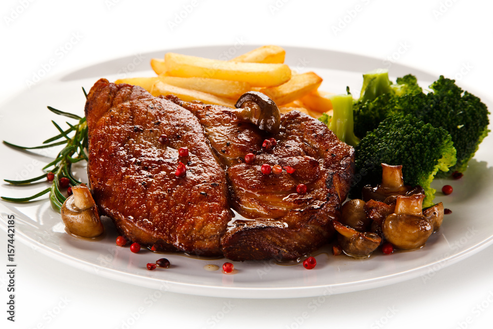 Grilled beefsteak with french fries and broccoli on white background