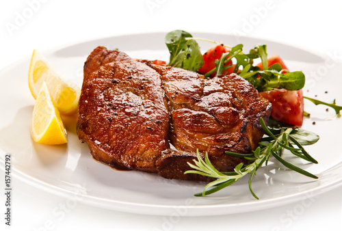 Grilled beefsteak with vegetables on white background