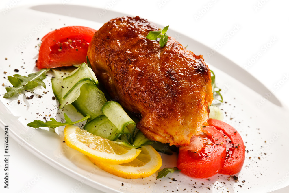Grilled chicken fillet with vegetables on white background Grilled chicken fillet with vegetables on white background